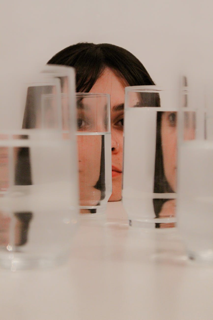 woman staring on glasses with water