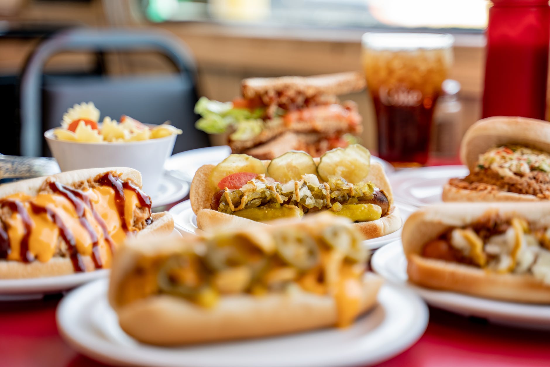 selective focus photography of burgers on plate on table